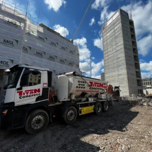 A Titan Concrete vehicle delivering concrete to a large city centre building site.