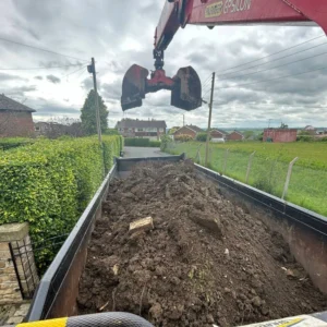 Grab hire wagon full of soil and garden waste.